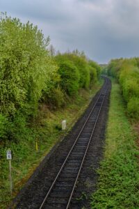 Railway tracks curve through lush greenery.